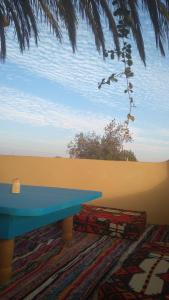 a blue table sitting on top of a rug at Fekry house in Qaryat Ḩātim aţ Ţāʼī