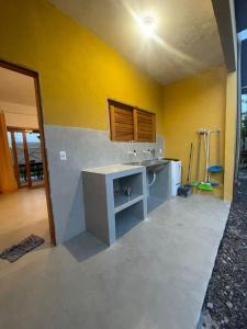 a bathroom with a sink in a room at Casa Refúgio do Rio in Caraíva +14 photos
