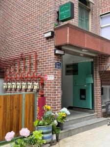 a entrance to a brick building with potted plants at 포레스트101 in Seoul