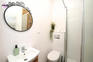 a bathroom with a sink and a mirror at MMRent Divine Room in Gdańsk