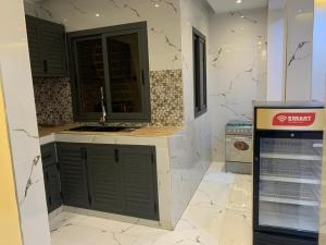a kitchen with a sink and a counter top at Résidence Salt Lake in Pikine +11 photos