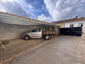 a truck parked in a garage next to a building at Refugio do Alto de Levira in Anadia
