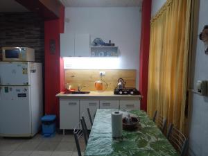 a small kitchen with a table and a refrigerator at Laura in Rosario