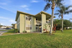 a house with a palm tree in front of it at Fair Seas Clipper Condo for 6 in Saint Augustine Beach +22 photos