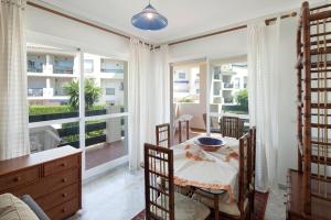 a dining room with a table and a large window at Lorcrimar 3 in Marbella