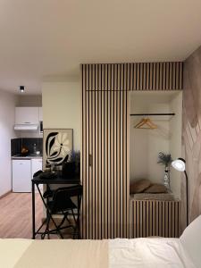 a bedroom with a bed and a desk and a table at Luméa 126 in Éguilles