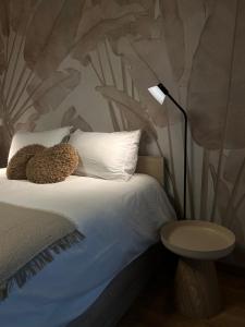 a bedroom with a bed with a teddy bear on it at Luméa 126 in Éguilles