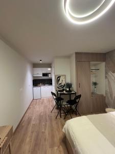 a bedroom with a bed and a table and chairs at Luméa 126 in Éguilles +16 photos