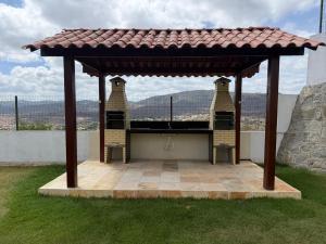 a gazebo with a roof on a patio at Domaine Residence in Gravatá