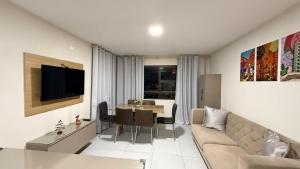 a living room with a couch and a table at Domaine Residence in Gravatá