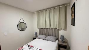 a small bedroom with a bed and a window at Domaine Residence in Gravatá +21 photos
