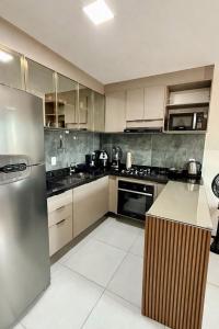 a kitchen with a stainless steel refrigerator and appliances at Domaine Residence in Gravatá