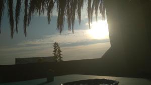 a window with a view of the sun in the sky at Fekry house in Qaryat Ḩātim aţ Ţāʼī