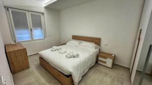 a bedroom with a bed with towels on it at Boutique Apartments Magenta in Magenta