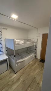 a small room with two bunk beds in it at Špeluňka in Luhačovice