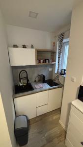 a small kitchen with a sink and a counter top at Špeluňka in Luhačovice