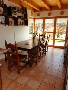 a dining room with a wooden table and chairs at Les Comblés des Combes in Ollon