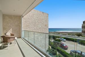 a balcony with a view of the ocean at Ocean View Haven Walk to Beach Private Rooftop Terrace in Akumal +37 photos