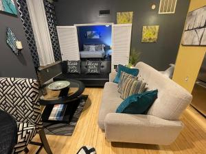a living room with a couch and a bed at The Samone's in Atlanta +5 photos