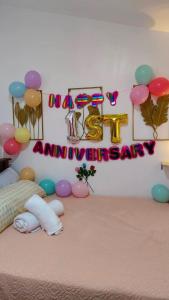 a room with a happy anniversary sign and balloons at Gee Staycation in Santo Tomas