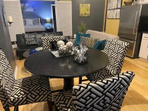 a black table and chairs in a living room at The Samone's in Atlanta