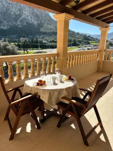 a table and two chairs on a balcony with a view at Pollensa apartament in Pollença