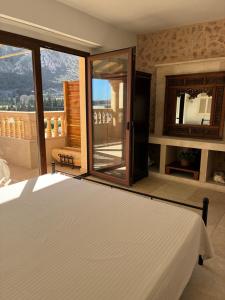 a bedroom with a bed and a large window at Pollensa apartament in Pollença