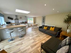 a living room with a couch and a kitchen at Mill Lane Holiday Cottage -Bath in Bath +17 photos