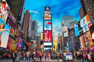 a crowd of people crossing a street in a city at Times Square Retreat with Private Bathroom and Kitchenette in New York +1 photo
