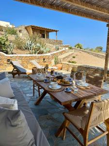 a wooden table with food on top of a patio at Aegean Paradise, Kythnos, Naousa in Kithnos