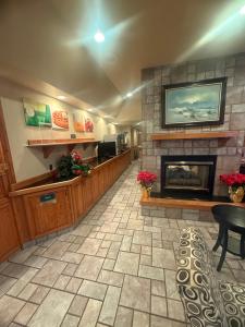 a waiting room with a fireplace in a restaurant at Naval Suites by FairBridge in Bremerton