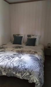 a bedroom with a large bed with plants on it at Chalet in Gouesnach