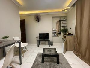 a living room with a table and a tv in it at Sharo's House in Cairo +20 photos