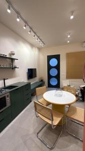 a kitchen with a table and chairs in a room at Beit'roun 2BR Apartment in Batroun in Batroûn