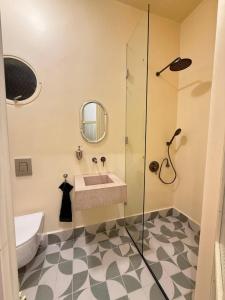 a bathroom with a sink and a shower at Beit'roun 2BR Apartment in Batroun in Batroûn