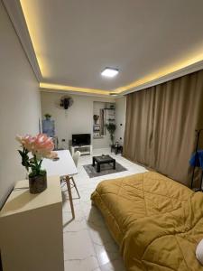 a bedroom with a bed and a living room at Sharo's House in Cairo