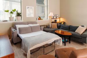 a living room with a couch and a table at Downtown Luxe 2BR Loft Apt | Sleeps 8 | Walkable in Milwaukee