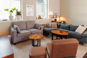 a living room with a couch and chairs and tables at Downtown Luxe 2BR Loft Apt | Sleeps 8 | Walkable in Milwaukee