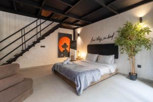 a bedroom with a large bed and a staircase at TWENTY SIX ANFA LUXURY RESIDENCE by Shortstaymaroc -Hyper Centre -Parking in Casablanca +280 photos