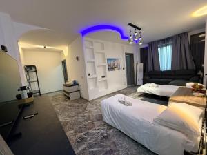 a hotel room with two beds and a purple light at DyAndy Suites Expo Milano in Baranzate