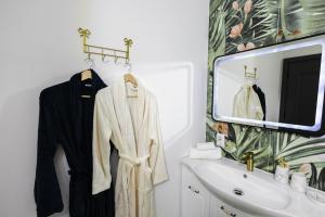 a white bathroom with a sink and a mirror at Cabana Almora in Dorna Arini +11 photos