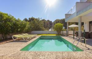 a swimming pool in the backyard of a house at Oasis N'aguait in Cala Ratjada