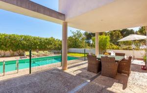 an outdoor patio with a table and chairs and a swimming pool at Oasis N'aguait in Cala Ratjada +43 photos
