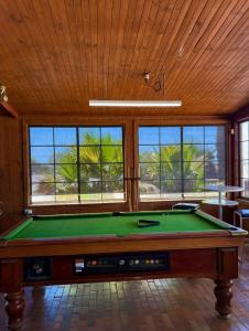 a pool table in a room with windows at Cadney Park Accommodation in Coober Pedy