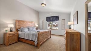 a bedroom with a large bed and a window at Altitude Adjustment in Red Lodge