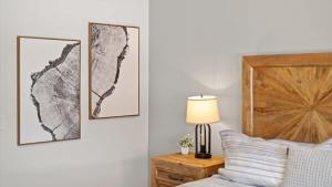 a bedroom with a bed and two pictures on the wall at Altitude Adjustment in Red Lodge