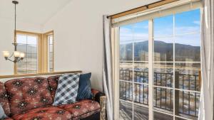 a living room with a couch and a large window at Mountain View Villa in Red Lodge