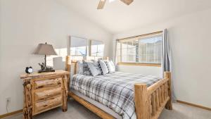 a bedroom with a wooden bed and a window at Mountain View Villa in Red Lodge