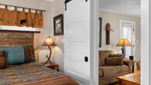 a bedroom with a bed and a couch and a chair at Beartraks in Red Lodge