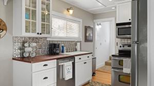 a kitchen with white cabinets and a counter top at Beartraks in Red Lodge